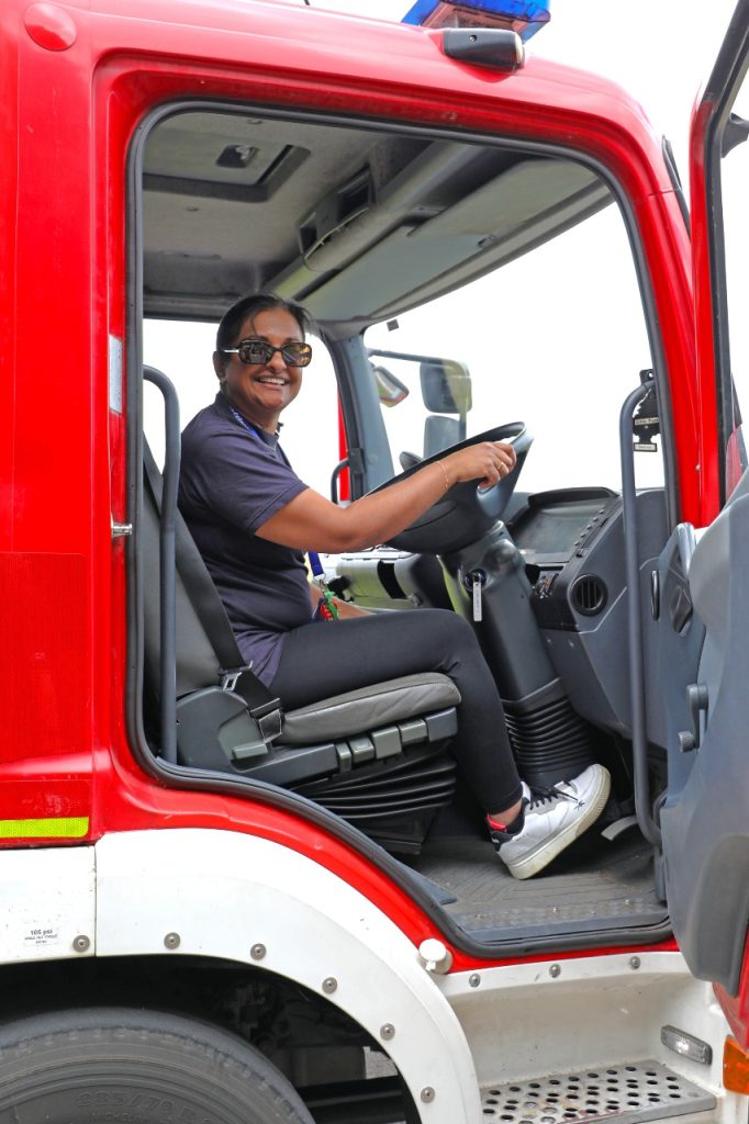 Smiling woman in the driving seat of a fire appliance