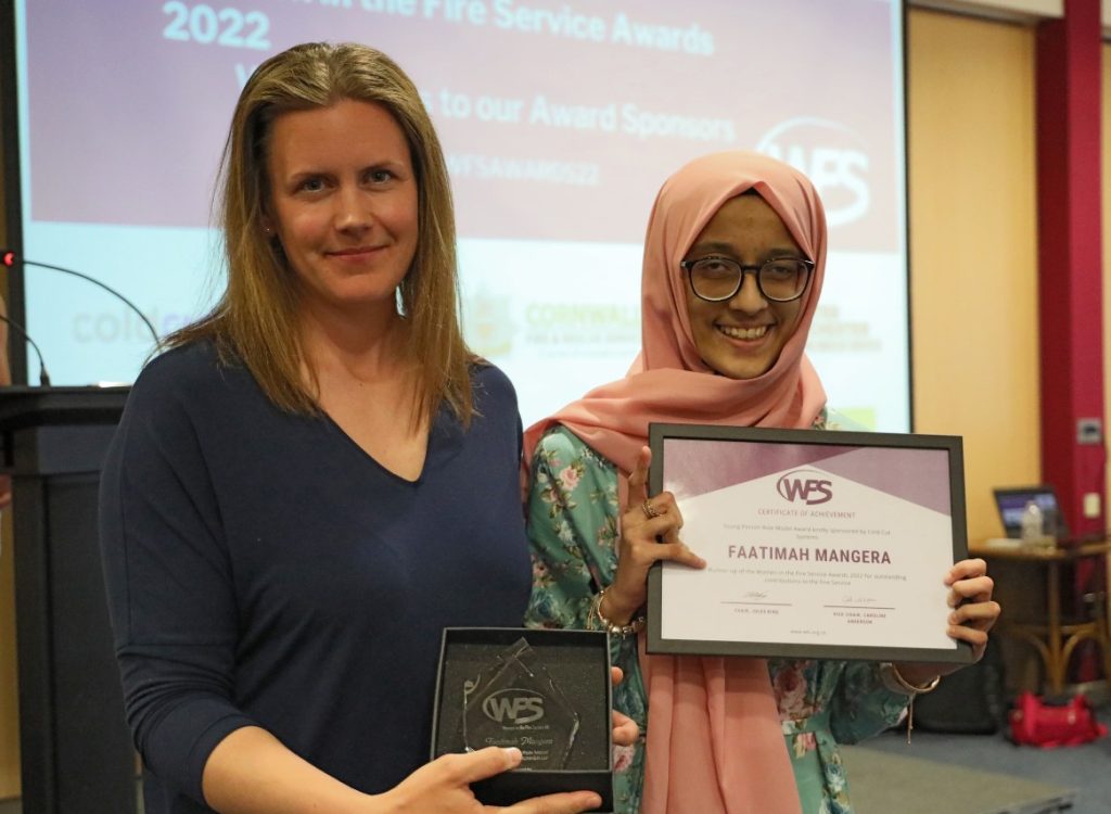 Woman being presented with a certificate and award 