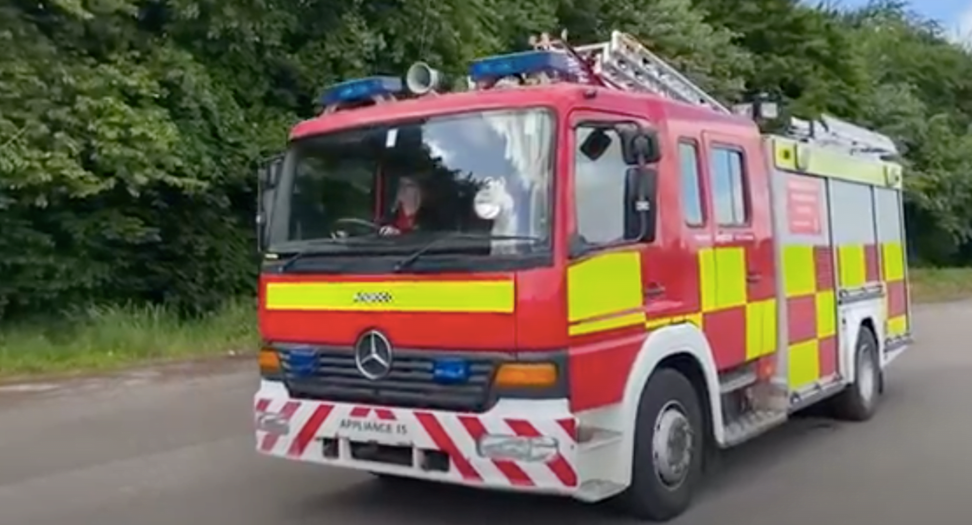 Woman driving a red fire appliance